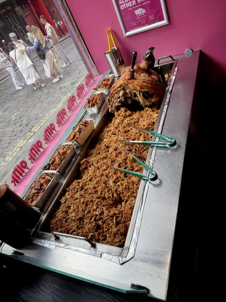 Whole roasted hog and pulled pork in the serving trough